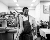 Chef Peter with a pig getting prepared for service